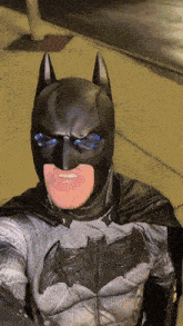 a man in a batman costume is smiling