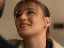 a close up of a woman 's face smiling
