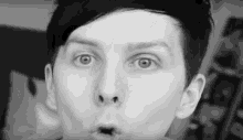 a close up of a person 's face in a black and white photo .