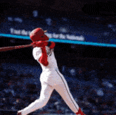 a baseball player for the nationals is swinging at a pitch