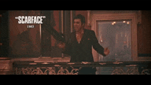 a scene from scarface 1983 with a man standing in front of a burning building