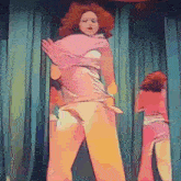 a woman in a pink dress is dancing on stage
