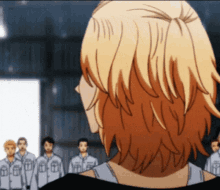 the back of a person 's head is shown in front of a group of men .