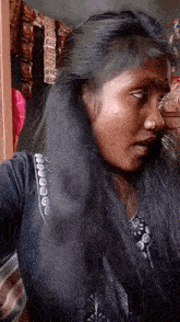 a woman with a nose ring and long black hair