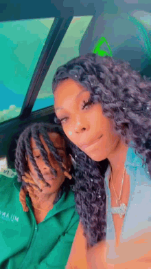 a man and a woman are sitting in a car together .