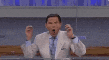 a man in a suit and tie is surrounded by pixelated faces