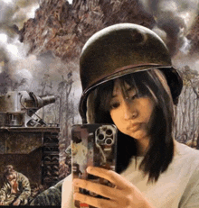 a woman wearing a helmet taking a selfie with her phone