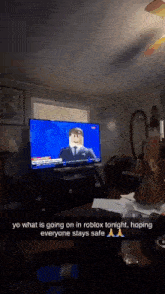 a tv screen shows a man with a beard on it