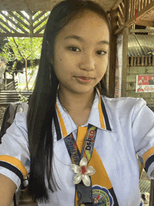 a girl is wearing a lanyard that says dgfed