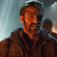 a man with a beard and a patch on his eye is wearing a brown jacket