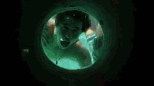 a man is swimming in a pool while a woman holds a bottle of beer .