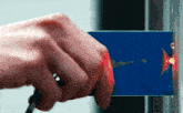 a person 's hand is holding a blue card that says hawaii on it