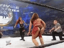 two women are wrestling in a wrestling ring with a sign that says survivor series