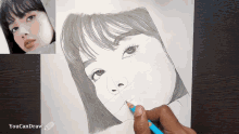 a person is drawing a woman 's face with a blue pencil and the words " youcandraw " on the bottom