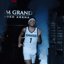 a basketball player in a dawgs jersey is running