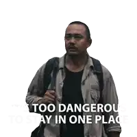 a man with a backpack has the words " it 's too dangerous to stay in one place " below him