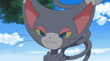 a cartoon cat with red eyes and a blue sky in the background