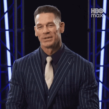 a man in a suit and tie is smiling and saying enjoy .