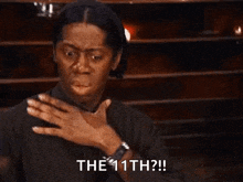 a woman is covering her mouth with her hand and says `` the 11th ? '' .