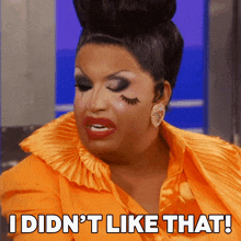 a drag queen says " i did n't like that " while wearing an orange dress