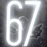 the number 67 is glowing in a black and white photo