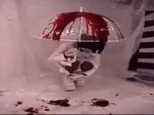 a person holding a bloody umbrella in a shower