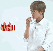 a man wearing glasses and a white shirt has a sticker that says ' i 'm hungry ' on it