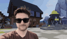 a man wearing sunglasses is taking a selfie in front of a minecraft village