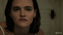 a close up of a woman 's face with the word stop written in white