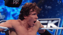 a man in a wrestling ring with his mouth open