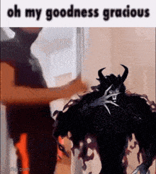 a man is standing next to a black monster with horns and the words `` oh my goodness gracious '' .