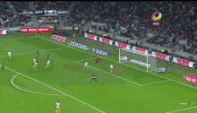 a soccer game is being played in a stadium with ads for telcel and infinitum