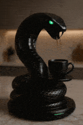 a statue of a snake pouring coffee into a cup