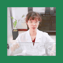 a woman wearing glasses and a lab coat has the letters tss on the front of her coat