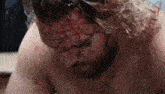 a close up of a man with blood on his face and chest