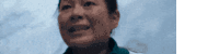 a close up of a woman 's face against a blue background