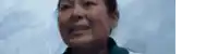 a close up of a woman 's face against a blue background