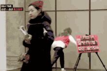 a woman in a red hat is standing in front of a sign that says oka time