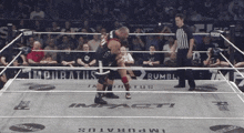 two wrestlers in a ring with the word impact on the ground