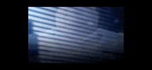 a blurred image of a window with blinds and a few lines of text