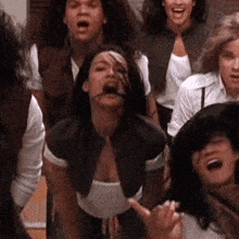 a group of people are singing together and one woman is screaming with her mouth open