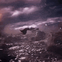 a person is falling through the air in a field