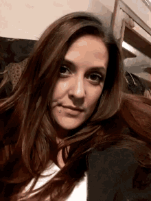 a woman with long hair and a nose ring
