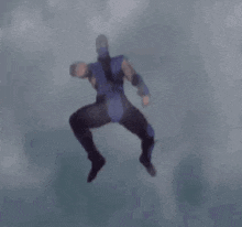 a man in a ninja costume is jumping in the air .