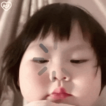 a close up of a baby making a funny face with her eyes closed and her mouth open .