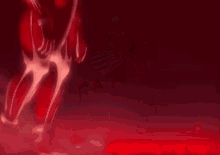 a person is standing in a dark room with a red light behind them .