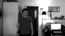 a black and white photo of a man wearing a shirt that says supreme