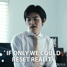 a man in a white shirt and orange tie says " if only we could reset reality "