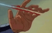 a close up of a person 's hand holding a bloody sword .