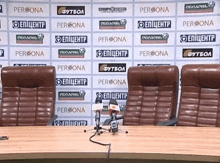 a row of chairs are sitting in front of a wall that says persona